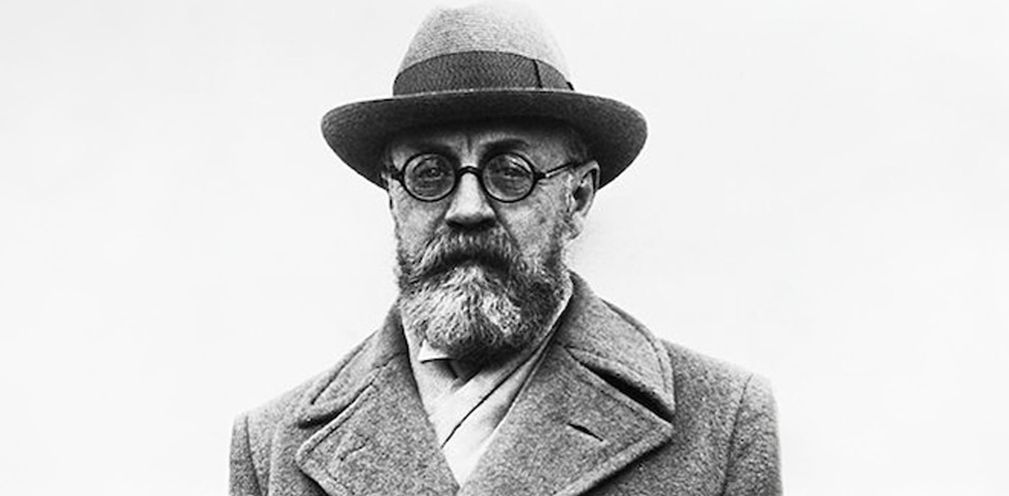 Henri Matisse, a revolutionary of color and form, seen here in his studio surrounded by the vibrant life he created through art.