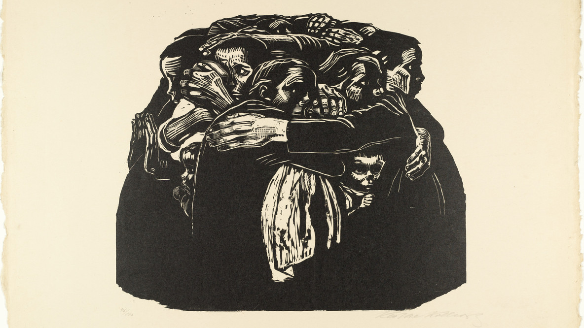Käthe Kollwitz with her sketchbook, gazing intently