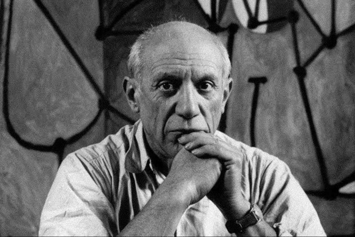 Pablo Picasso, photographed later in life, surrounded by his sculptures and paintings—an artist who never stopped creating.