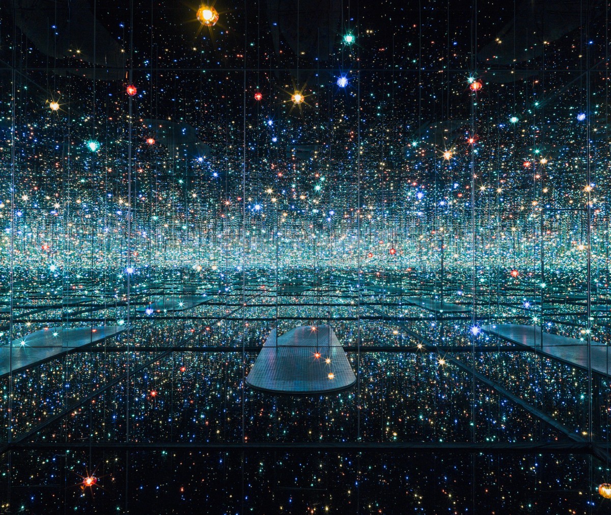Yayoi Kusama’s Infinity Mirror Room with bright lights reflecting endlessly, featuring her signature polka dot pattern.
