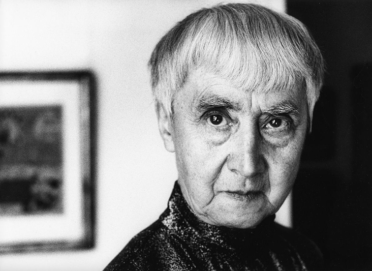 Photograph of Hannah Höch with short hair and a quiet but confident demeanor in her Berlin studio.