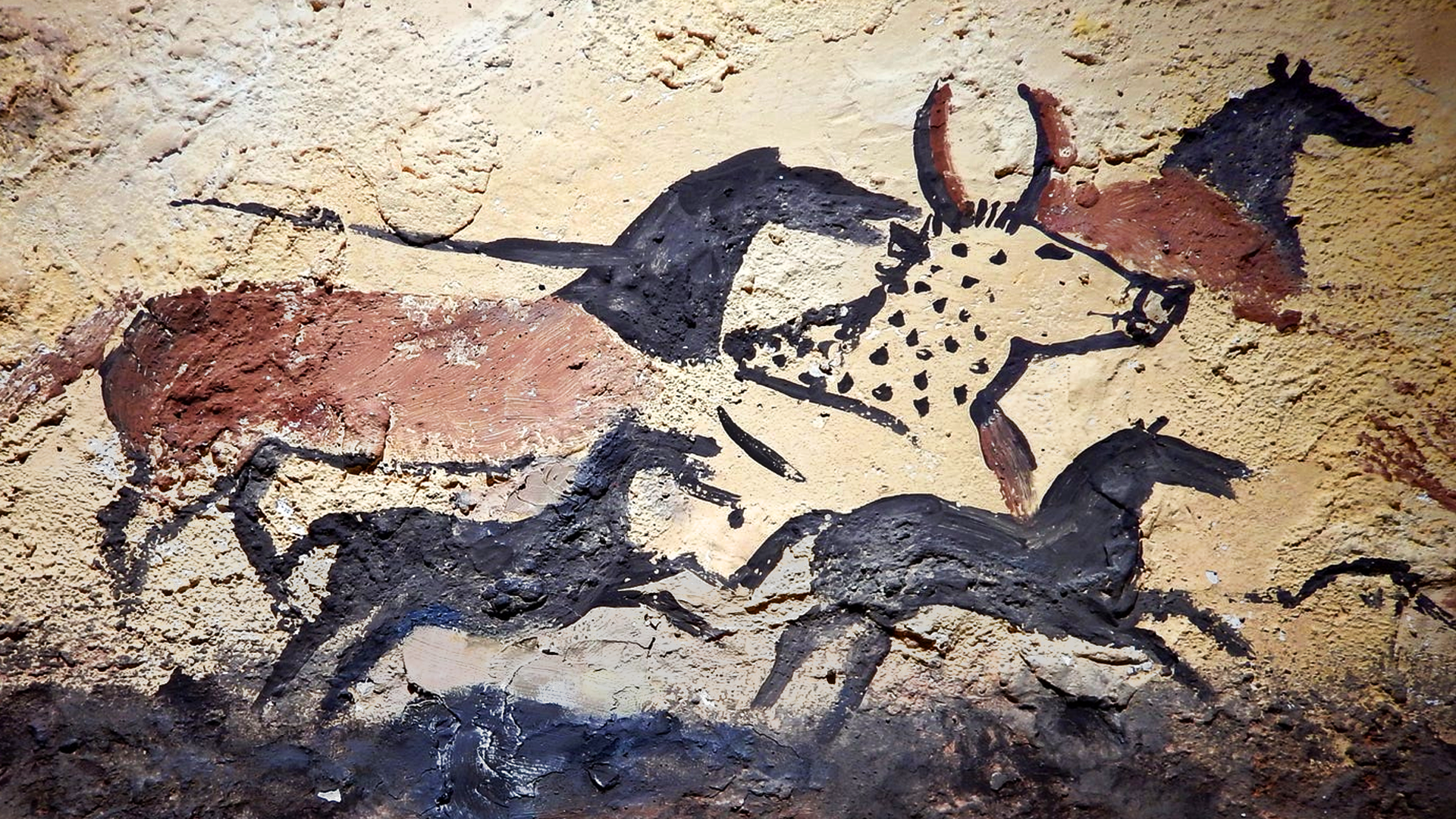 The Hall of the Bulls inside the Lascaux caves in France, with giant aurochs painted in sweeping black lines.