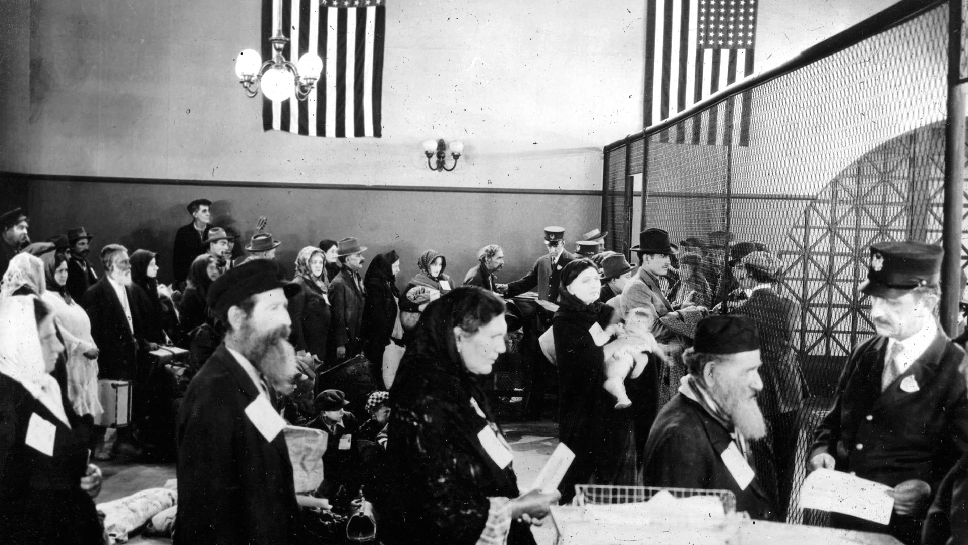 Immigrants arriving at Ellis Island in the early 1900s, carrying luggage and hope.
