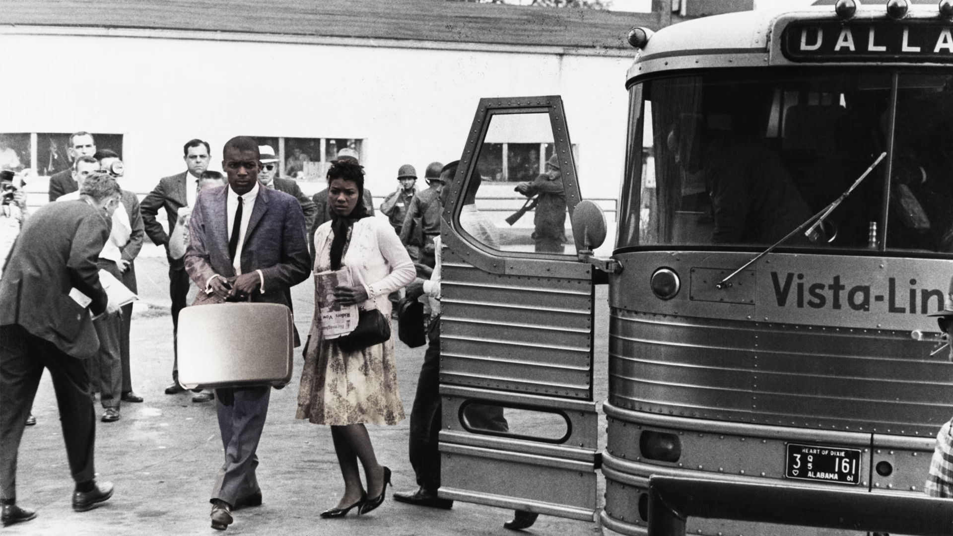 Interracial group of Freedom Riders boarding a bus during the Civil Rights Movement