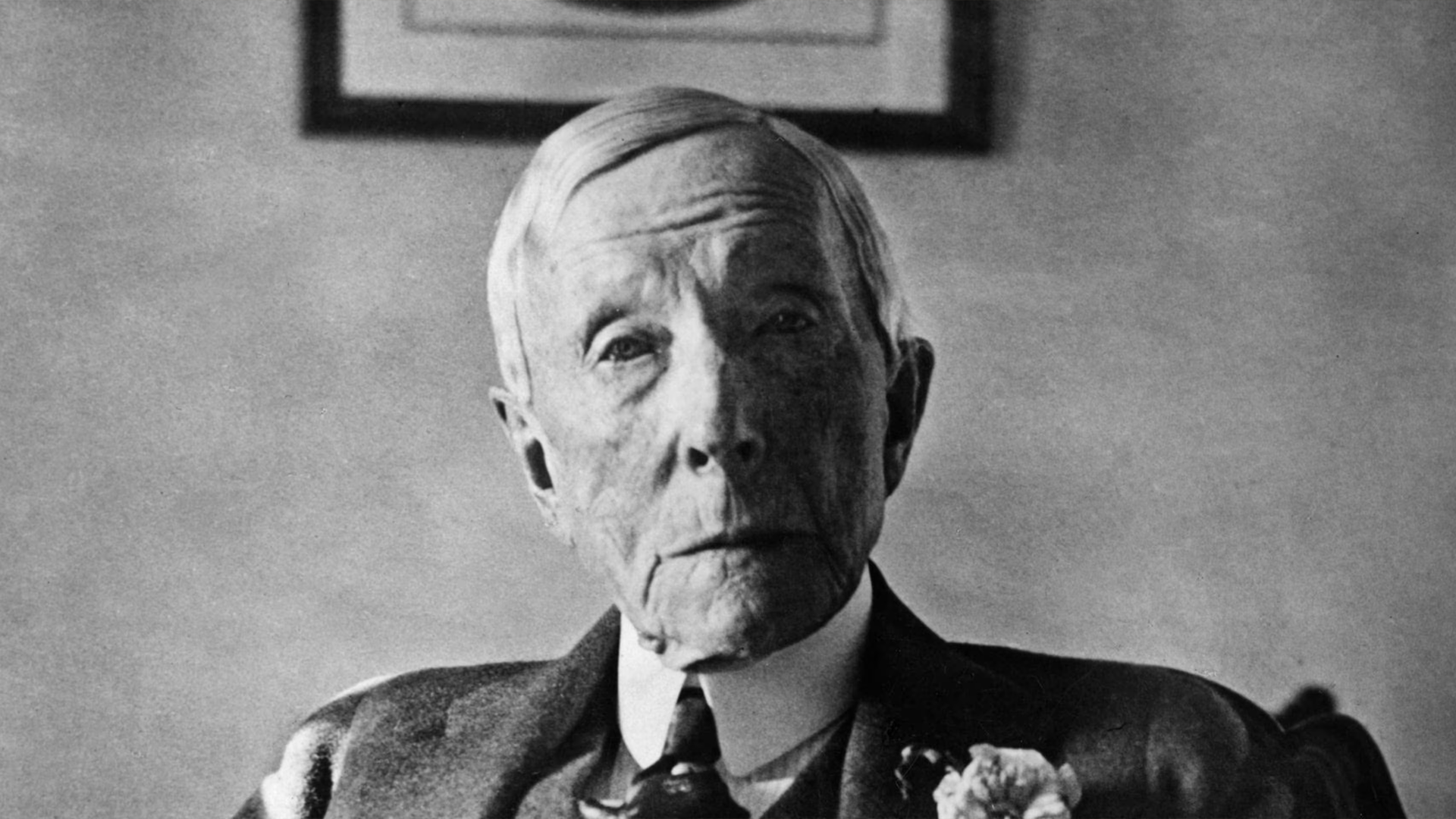 Portrait of John D. Rockefeller with an oil refinery in the background.