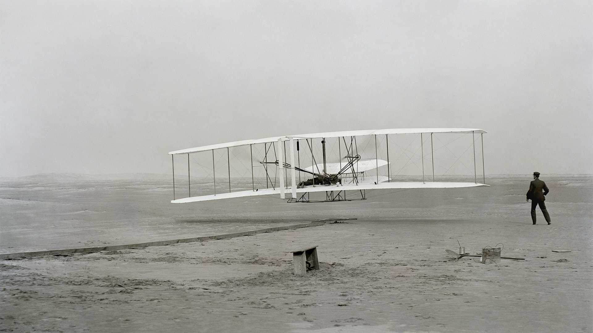 The Wright brothers’ first powered airplane lifts off the ground at Kitty Hawk, North Carolina, marking the birth of human flight.