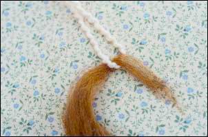 Attaching wool to leader.