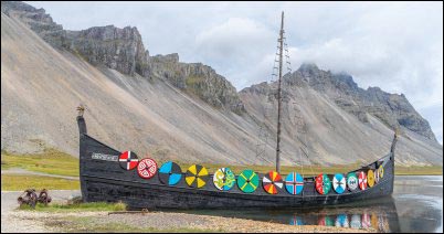 Stokksnes, Iceland - August 12, 2025, Viking longship on the black sand beach of Stokksnes at the foot of the majestic Mount Vestrahorn