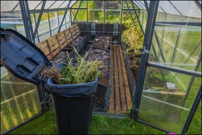 Close up view of open greenhouse during cleaning preparation for winter season. 
