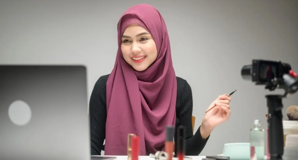 Entrepreneur doing makeup tutorial on camera