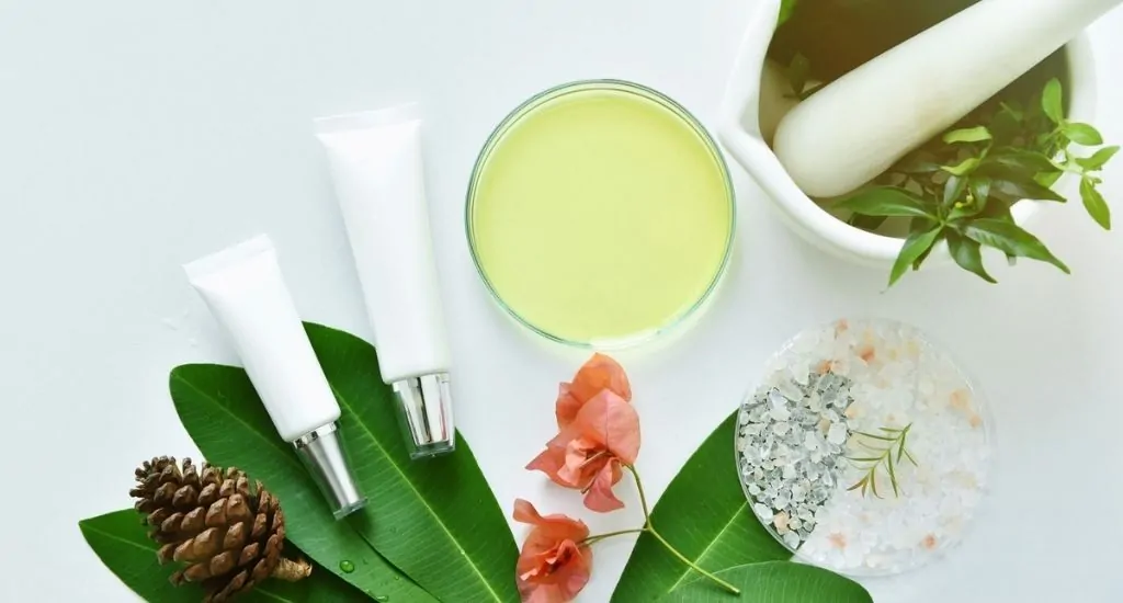 Cosmetic bottle containers with green herbal leaves