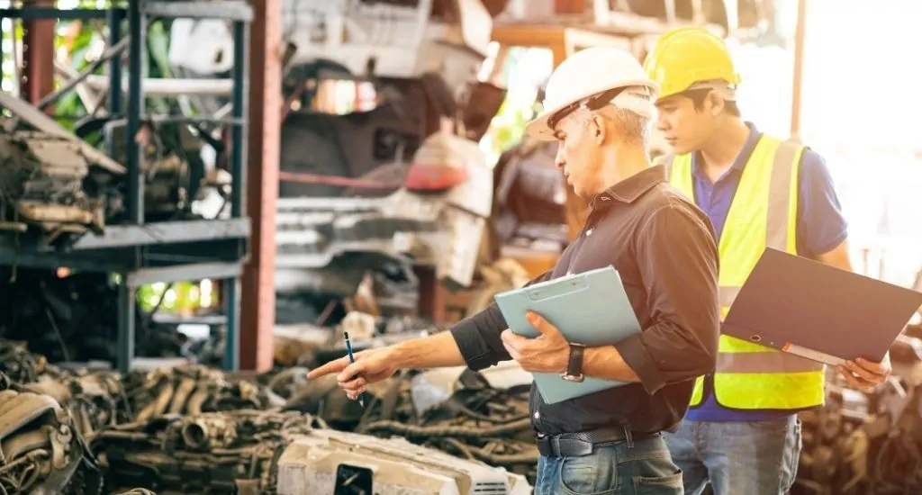 Immigrant entrepreneur directing employee in warehouse