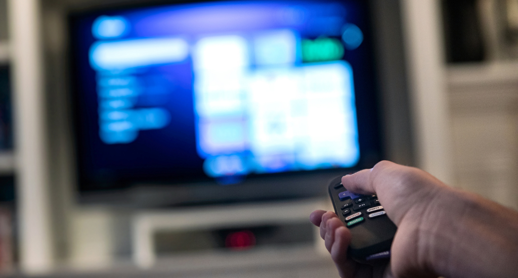 An entrepreneur finding what to watch on a TV