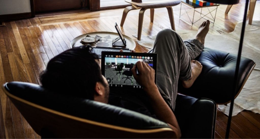 Entrepreneur laying back in chair while marketing planning on tablet