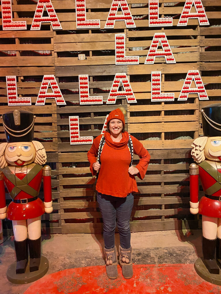 woman standing next to toy soldiers