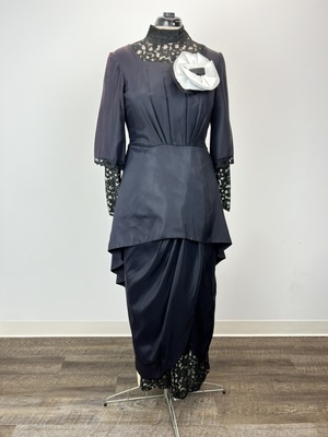 Ascot Black Dress with Peplum and Large White Flower