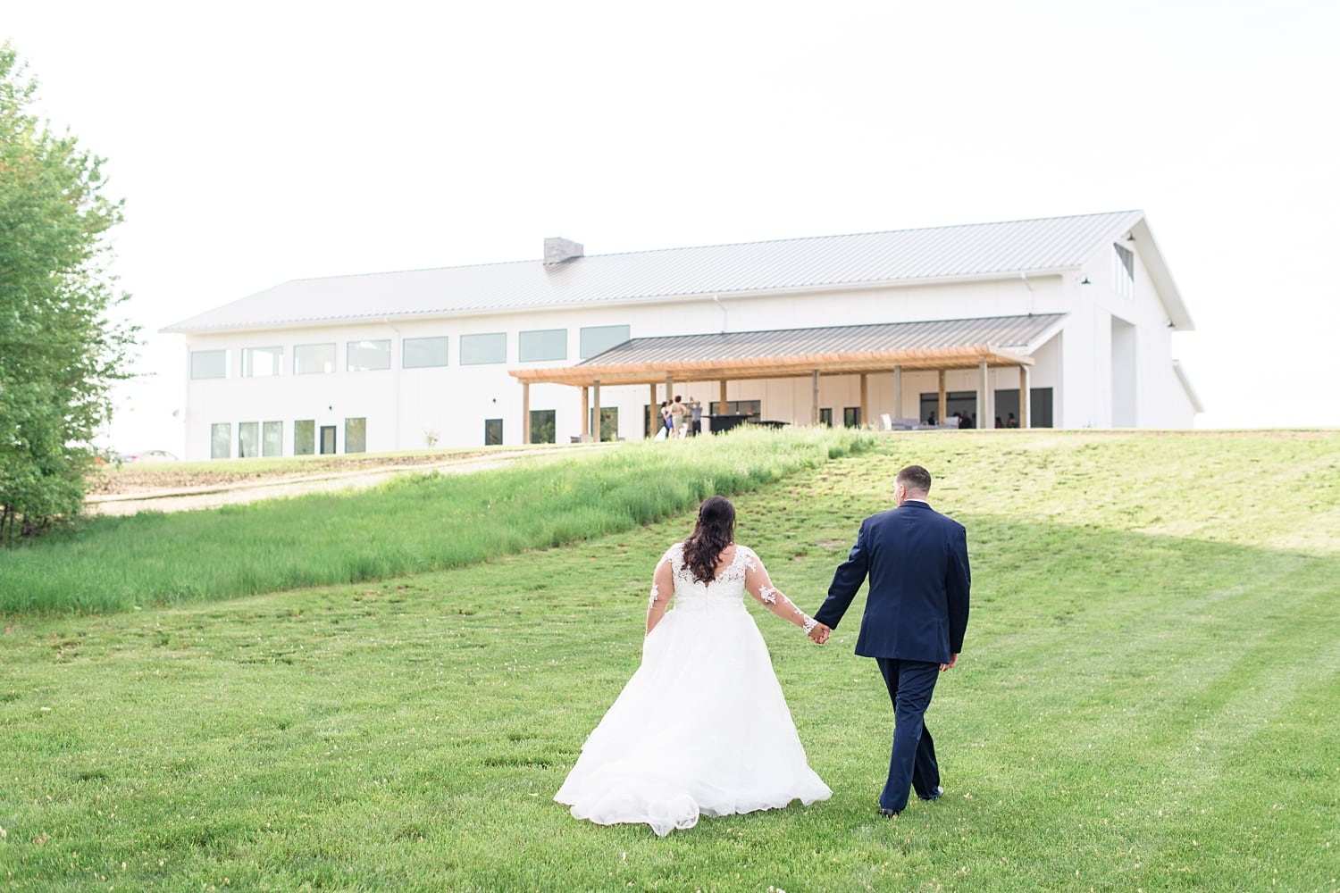 emerald hills events bride and groom walking up the hill