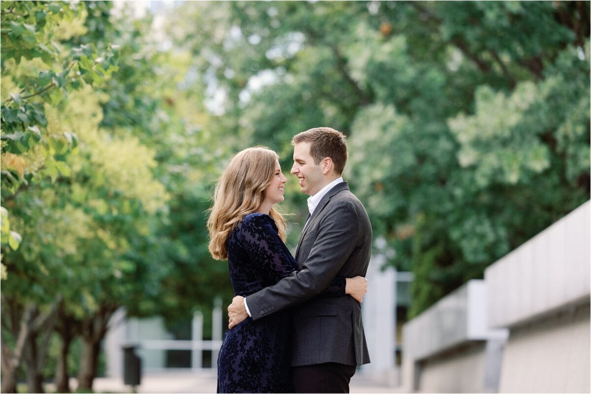 Couple embraces during engagement photo session in Downtown Des Moines 