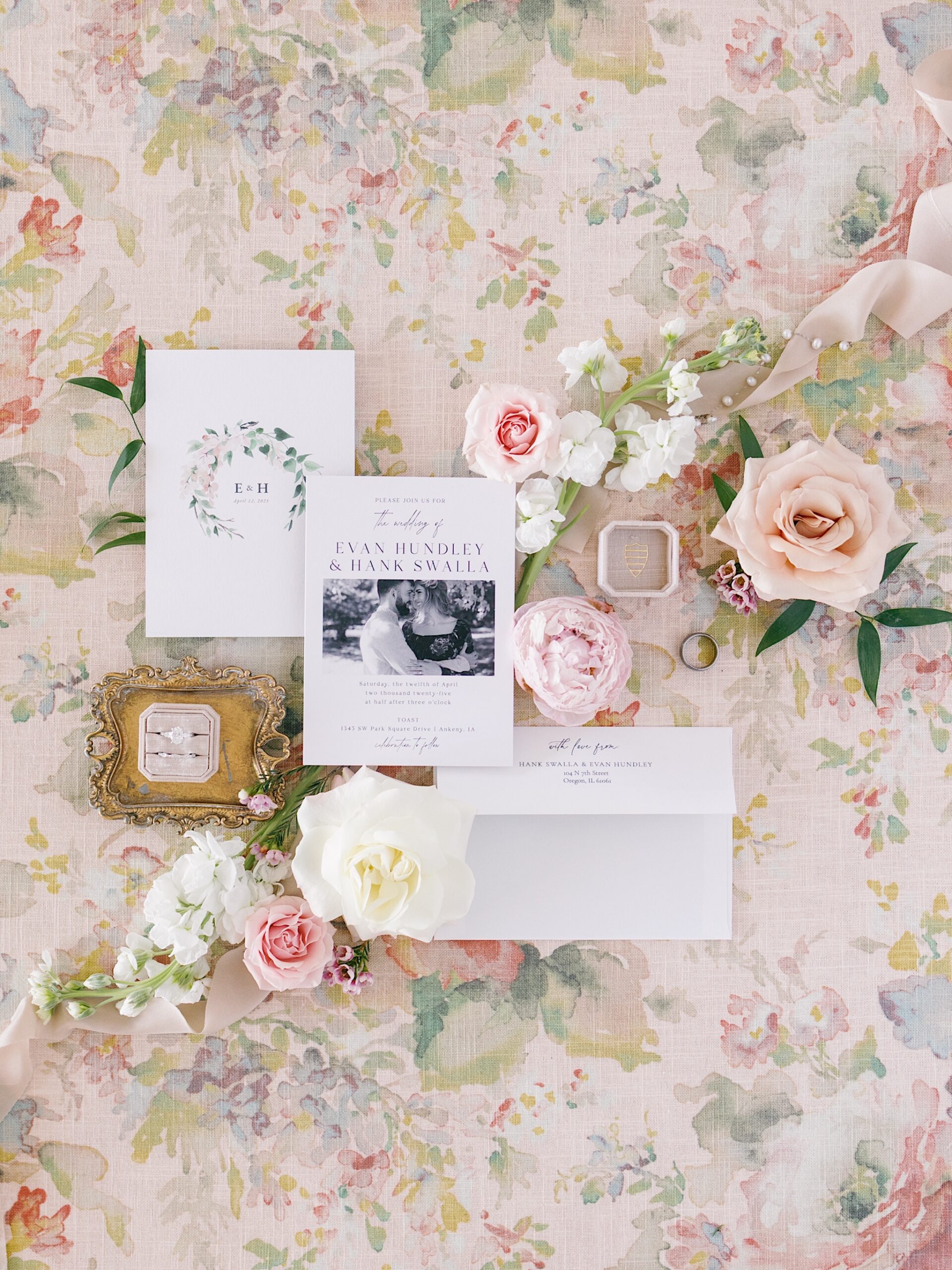 Elegant wedding invitation suite with floral accents and soft pastel color palette.