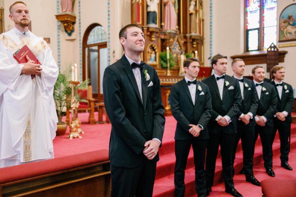 Bride and groom exchanging vows during a Catholic ceremony at St. Mary’s Catholic Church in Iowa City.