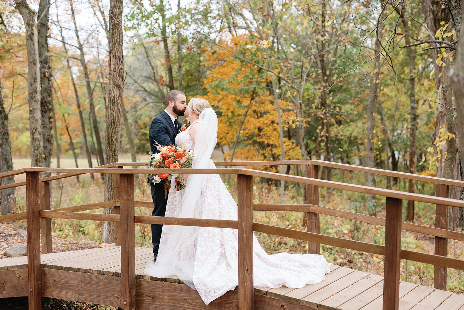 fall country lane lodge wedding photos on wooden bridge