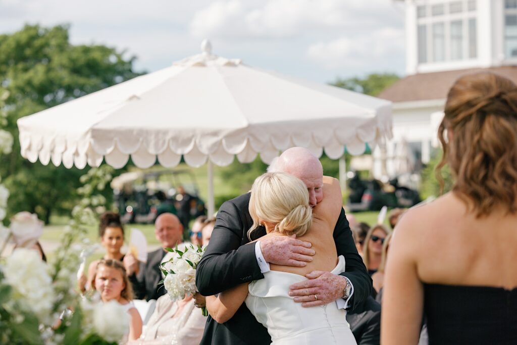 Bride hugs dad on wedding day