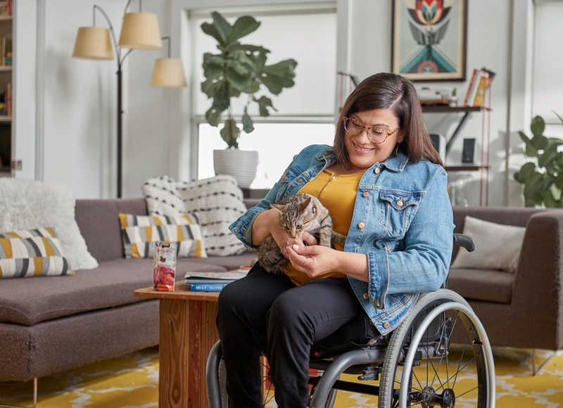 girl in wheelchair holding cat
