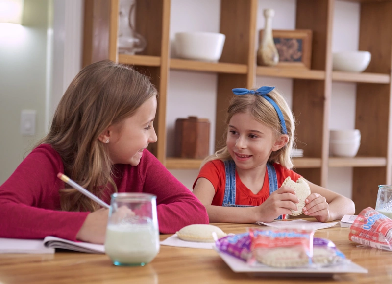 two girls eating uncrustables