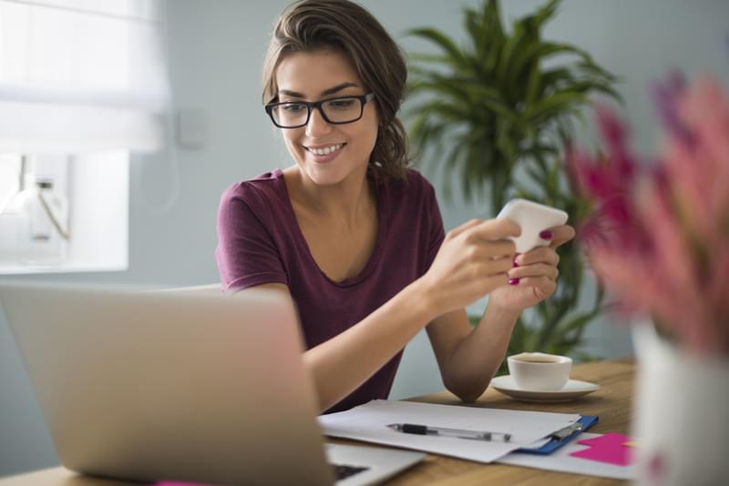 woman on phone and computer