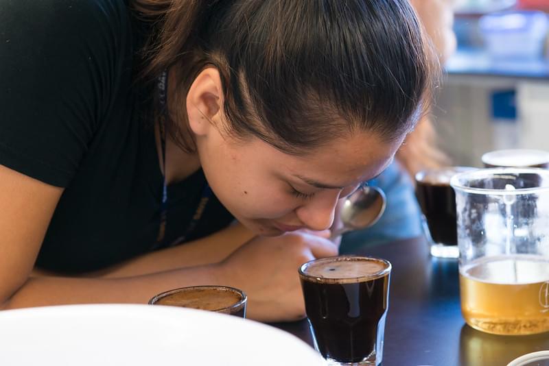 woman smelling coffee