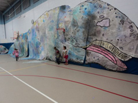 Students with life-size gray whale art they created