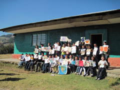 Children receiving symbolic monarch butterflies in Mexico.