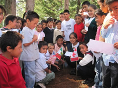 Children receiving symbolic monarch butterflies in Mexico.