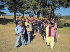 Children receiving symbolic monarch butterflies in Mexico.