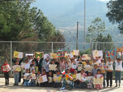 Children receiving symbolic monarch butterflies in Mexico.