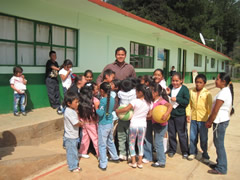 Children receiving symbolic monarch butterflies in Mexico.