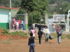 Children receiving symbolic monarch butterflies in Mexico.