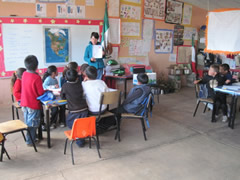 Children receiving symbolic monarch butterflies in Mexico.