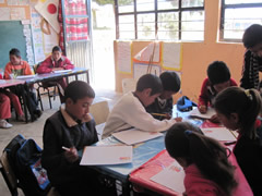 Children receiving symbolic monarch butterflies in Mexico.