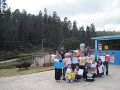 Children receiving symbolic monarch butterflies in Mexico.