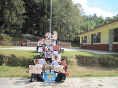 Children receiving symbolic monarch butterflies in Mexico.