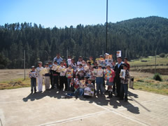Children receiving symbolic monarch butterflies in Mexico.