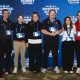 Six Richmond Flying Squirrels staff members pose in front of a 2026 MiLB Business Summit backdrop in Louisville, with one holding the Organization of the Year trophy.