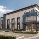 Rendering of a two-story stone and glass Onelife Fitness building on a street corner at Midtown64