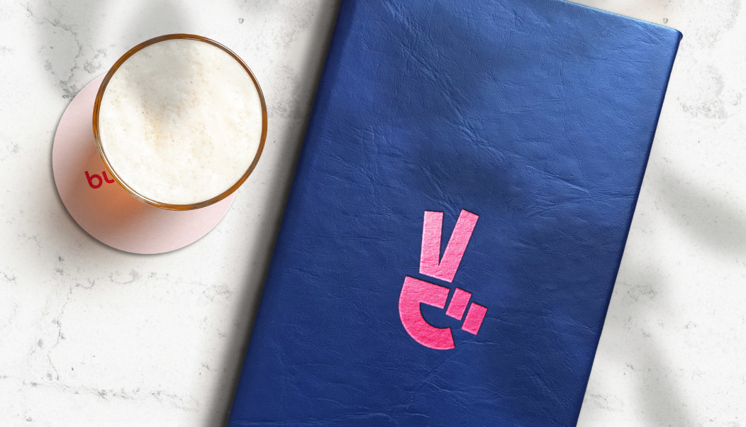 Bulma bar restaurant menu design by graphic designer with a beer on the side on a marble counter.