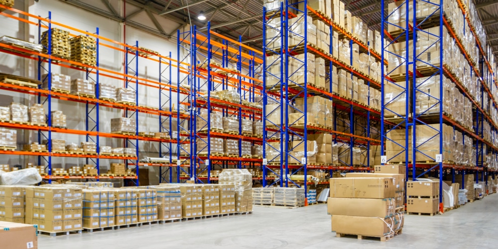 Interior of a modern warehouse storage of retail shop with pallet truck near shelves