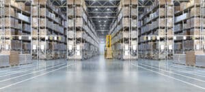 Huge distribution warehouse with high shelves and loaders.