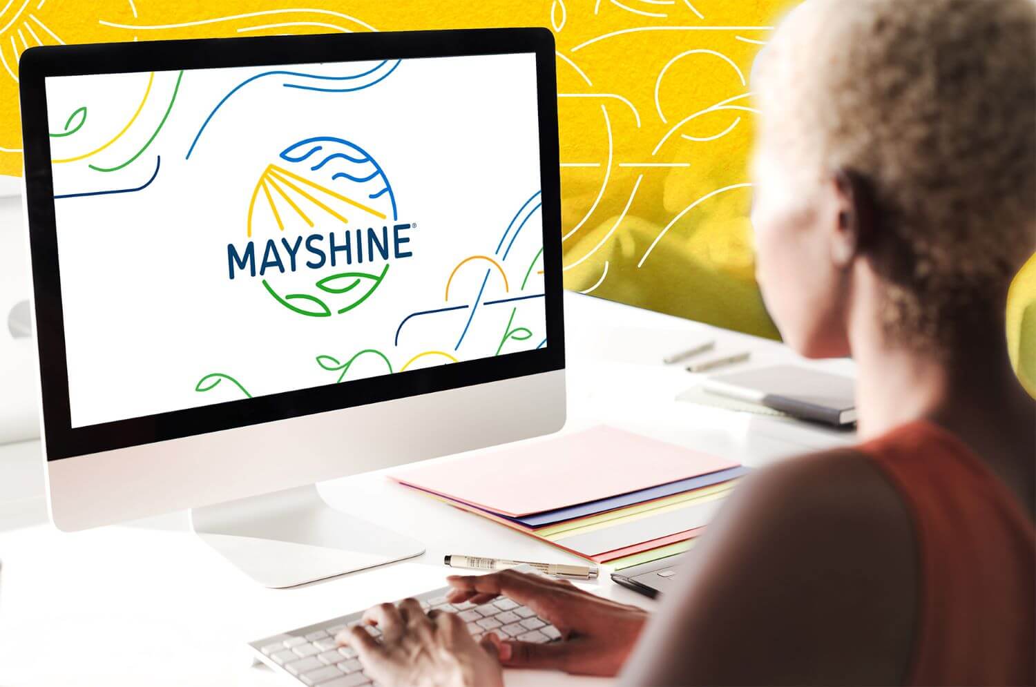 "Integrating Mobile & Social Media Fundraising Tools Effectively" - main blog image - Person on a desktop computer with the screen showing a large Mayshine logo
