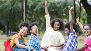 A group of 5 students engaged in a discussion outdoors