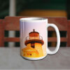 White nautical coffee mug with an image of a lighthouse at sunset, featuring warm orange and yellow hues.